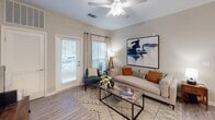 This single-floor residence at 557 Roanoke Rd in Daleville, Virginia, offers a thoughtfully designed layout with modern finishes throughout. The open-concept living and dining area serves as the heart of the unit, featuring wood-style flooring, neutral tones, and a vaulted ceiling with a ceiling fan that enhances the sense of spaciousness. A door in the living room provides direct outdoor access and brings in natural light.

The kitchen is well-equipped with stainless steel appliances, including a refrigerator, range, and microwave. Crisp white shaker cabinetry pairs with granite countertops, and a breakfast bar peninsula connects the kitchen seamlessly to the dining area.

Two bedrooms offer comfortable retreats, each with plush carpeting, ceiling fans, and windows that invite natural light. The primary bedroom includes an en-suite bathroom featuring a long vanity with white cabinetry, a large mirror, and wood-style flooring. A second full bathroom provides a tub-shower combination, a single-sink vanity, and matching flooring.

A dedicated in-unit laundry room houses a full-sized washer and dryer with overhead shelving, adding everyday convenience to this polished Daleville residence.