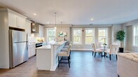 Located at 85 Martin Luther King Ave in Morristown, NJ, this thoughtfully designed 2-bedroom, 1-bathroom single-floor residence offers a bright and modern living experience. The open-concept kitchen and living area serves as the heart of the home, featuring white shaker cabinetry, a striking quartz waterfall island with seating for three, pendant lighting, stainless steel appliances, a subway tile backsplash, and a dedicated wall-mounted range hood. Hardwood flooring flows throughout, unifying the space with warmth and continuity. The adjacent dining area is bathed in natural light from an array of large windows overlooking lush greenery. The spacious living room continues the light-filled theme with multiple windows, recessed lighting, and generous room for entertaining. The generously sized primary bedroom features a large double-door closet, light wood flooring, and easy hallway access. The second bedroom is bright and airy with natural light streaming through a large window. The full bathroom is elegantly appointed with subway tile surround, a tub-shower combination, white vanity with integrated sink, and neutral tile flooring. A dedicated hallway with closet storage connects all rooms efficiently, completing this well-appointed Morristown residence.
