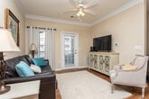 Located at 40 Chateau Dr SE in Rome, Georgia, this single-floor residence offers a thoughtfully designed layout that balances comfort and functionality. The open-concept kitchen and dining area serves as a central hub of the home, featuring white cabinetry that extends to the upper walls, a stainless steel refrigerator, a kitchen island with bar seating, and warm hardwood-style flooring that flows seamlessly into the adjacent dining space. Crown molding adds a refined architectural detail throughout the common areas.

The living room is a welcoming, light-filled space with rich hardwood flooring, crown molding, a ceiling fan, and a glass-panel door that opens to an outdoor area, allowing abundant natural light to fill the room. Large windows dressed with sheer curtains enhance the airy ambiance.

The bedrooms are carpeted and serene, each featuring ceiling fans, large windows with blinds and curtain panels, and ample space for furnishings. The warm, neutral wall tones throughout the home create a cohesive and calming atmosphere. Overall, this residence combines practical design with comfortable living spaces, making it a well-rounded home in the Rome, Georgia community.
