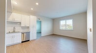 Located on Tenth Street West in Bradenton, Florida, this well-appointed 2-bedroom, 2-bathroom residence offers a clean, modern aesthetic across a single floor. Light-toned luxury vinyl plank flooring runs throughout the home, complementing the bright, neutral color palette that creates an airy and welcoming atmosphere.

The kitchen is a standout feature, equipped with a full suite of stainless steel appliances including a refrigerator, range, microwave, and dishwasher. White shaker-style cabinetry extends to the ceiling for ample storage, while granite countertops and a subway tile backsplash add a polished, contemporary touch.

The open living area receives natural light through a window with views of the surrounding neighborhood. Both bedrooms are comfortably sized, with the primary bedroom offering a dedicated closet and natural light via a window overlooking greenery. A walk-in closet with wire shelving provides generous storage in the secondary bedroom.

Each bathroom is finished with marble-style tile, a granite-topped vanity, and a tub-shower combination. A stacked in-unit washer and dryer adds everyday convenience. A connecting hallway ties the layout together efficiently, making excellent use of the available space throughout this thoughtfully designed Bradenton residence.