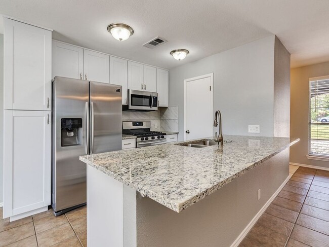 kitchen with stainless steel appliances - 7308 Grand Canyon Dr