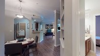 Located at 3378 Greenbriar Pkwy in Atlanta, GA 30331, this well-appointed single-floor residence offers a thoughtfully designed open-concept layout that promotes a seamless flow between living spaces. Rich hardwood-style flooring runs throughout the main areas, complemented by elegant crown molding and decorative arched doorways that lend architectural character to the interior.

The expansive living area is bright and inviting, featuring large windows that allow generous natural light to fill the space. A graceful arched pass-through connects the living and dining areas, while built-in shelving adds both style and functionality. The dining area comfortably accommodates a full dining set, situated adjacent to the kitchen.

The kitchen is equipped with dark cabinetry, black appliances including a refrigerator, range, and dishwasher, and tile flooring. A convenient pass-through bar connects it to the dining space. Directly off the kitchen, a dedicated laundry room houses a full-size washer and dryer.

The bedrooms are carpeted for comfort, each offering natural light from well-placed windows. The bathroom features a soaking tub with classic white tile surround accented by decorative diamond-pattern tile trim. Throughout the residence, a cohesive cool-gray color palette creates a calm, modern ambiance.