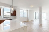 Located in the heart of Fort Lauderdale, this sophisticated 2-bedroom, 3-bathroom residence offers a refined, contemporary living experience. The open-concept kitchen and living area is the centerpiece of the home, showcasing light herringbone-patterned hardwood floors that run throughout the entire space. Expansive floor-to-ceiling windows and sliding glass doors flood the living room with natural light while framing sweeping panoramic views of the Fort Lauderdale skyline and beyond.

The chef's kitchen is outfitted with rich walnut cabinetry, a striking waterfall-edge marble island, stainless steel appliances, and a marble tile backsplash, all illuminated by elegant pendant lighting. Each bedroom is generously proportioned, bathed in natural light, and features the same herringbone hardwood flooring. The primary bedroom includes access to a well-organized walk-in closet with custom built-in shelving. The bathrooms are elegantly appointed with dual-sink vanities, warm wood cabinetry, and marble-tiled glass-enclosed showers. A dedicated in-unit laundry room with a stacked washer and dryer adds everyday convenience. Clean white walls, an airy hallway, and a cohesive modern palette give this residence a bright, polished ambiance throughout.