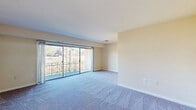 Located at 5521 Marlboro Pike in District Heights, MD, this generously sized 3-bedroom, 1-bathroom unit spans a single floor, offering a notably expansive layout well-suited for comfortable everyday living. The living area features plush carpeting and large sliding glass doors that open onto a balcony, allowing natural light to fill the space while providing open views of the surrounding neighborhood and green lawn below.

The galley-style kitchen is efficiently designed with warm oak cabinetry, light-toned countertops, a stainless steel gas range, and a black refrigerator. Tile flooring completes the functional layout, providing ample counter and storage space along both walls.

Each of the three carpeted bedrooms is finished with neutral-toned walls and clean white baseboards. The spacious primary bedroom features dual bi-fold closets, offering generous storage. Secondary bedrooms each include their own closet and windows that introduce natural light. The full bathroom is equipped with a tub-shower combination and tile flooring. Throughout, the unit maintains a clean, neutral palette that lends itself to a versatile and move-in-ready living environment.
