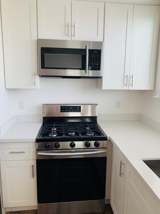 New Samsung range and microwave hood. New cabinets with lots of storage. - 2197 Golden Gate Avenue