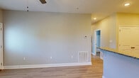 Located at 4938 Worth Way in Bowling Green, Kentucky, this well-appointed 2-bedroom, 2-bathroom unit offers a thoughtfully designed single-floor layout with modern finishes throughout. The kitchen is a standout feature, showcasing crisp white shaker cabinetry, granite countertops, and a full suite of stainless steel appliances including a range, over-the-range microwave, and refrigerator. Light wood-style flooring flows seamlessly through every room, complementing the soft neutral wall tones that create a clean, cohesive aesthetic.

The open kitchen connects to a dining and living area, providing a functional and airy feel. The spacious primary bedroom features a ceiling fan, natural light from a large window with blinds, and closet access. The second bedroom is well-proportioned and equally bright, maintaining the same consistent finishes.

Both bathrooms are finished with granite-topped white vanities and wood-style flooring. The primary bath includes a tub-shower combo, while the second bath mirrors the same clean, practical design. Ceiling fans are present in multiple rooms for added comfort. The unit's understated, move-in-ready condition makes it a practical and attractive option in the Bowling Green area.