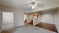 Located at 2222 N St Augustine Dr in Dallas, TX, this single-story 2-bedroom, 2-bathroom home offers a practical and comfortable layout designed for everyday living. The open-concept living, dining, and kitchen area forms the heart of the home, with plush carpet underfoot in the living space and a ceiling fan overhead. A pass-through peninsula connects the kitchen to the main living area, enhancing the sense of openness. The kitchen is well-equipped with warm oak cabinetry, ample counter space, a double-basin stainless steel sink, and white appliances including a refrigerator, electric range, built-in microwave, and dishwasher. Rich wood-look flooring runs through the kitchen and bathrooms, adding a cohesive design element throughout. Both bedrooms feature carpet, ceiling fans, and windows that bring in natural light. The primary bedroom includes its own closet access. The two bathrooms are appointed with oak vanities, light countertops, and large mirrors. A dedicated office provides flexible space for work or study. The in-unit laundry room includes a washer and built-in wall shelving for added storage. With four closets spread throughout, storage is plentiful in this thoughtfully arranged home.
