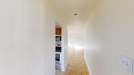 This well-designed 1050 square foot residence offers a harmonious blend of comfort and functionality. The single-story layout comprises three bedrooms, including a generously sized primary bedroom of 170 square feet, two full bathrooms, and a variety of living spaces. The heart of the home is a modern kitchen, featuring oak cabinetry, stainless steel appliances, and an attractive tiled backsplash. The living areas boast a mix of tiled and carpeted flooring, providing both durability and comfort. Large windows and sliding glass doors in select rooms flood the space with natural light, creating an airy ambiance. The bathrooms are equipped with essential fixtures and tiled surfaces for easy maintenance. A dedicated laundry room adds convenience to daily life. The property also includes three closets for ample storage. With its neutral color palette and practical design, this home presents a versatile canvas for personalization while offering all the necessities for contemporary living.