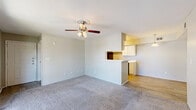 Located at 305 W Baker Rd in Baytown, TX, this single-floor, 2-bedroom, 2-bathroom home offers a practical and comfortable layout. The living room serves as the heart of the home, featuring plush carpeting, a ceiling fan with light fixture, and large sliding glass doors that open to a private balcony, filling the space with natural light and outdoor views. A half-wall pass-through connects the living area to the kitchen, creating an open, connected feel. The galley-style kitchen is efficiently designed with white cabinetry, light countertops, wood-look vinyl flooring, a black refrigerator, electric range, dishwasher, and a dedicated pantry for additional storage. A separate dining area provides space for everyday meals. The primary bedroom includes plush carpet, a walk-in closet with built-in shelving, and a private en-suite bathroom. The second bedroom is carpeted as well, featuring a window that brings in natural light. Three closets throughout the home provide ample storage. A hallway connects all rooms, adding to the functional flow of the floor plan. The home combines practical design with everyday comfort, making it a well-rounded residence in Baytown.