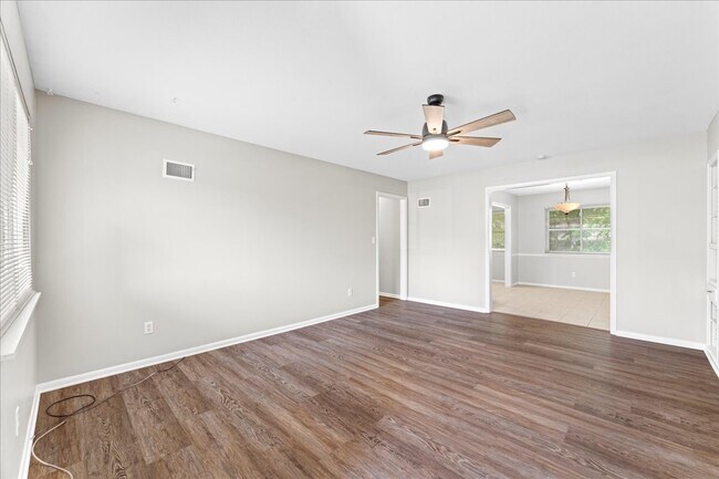 Living room with view of hallway and dining room - 8021 Holmes Rd
