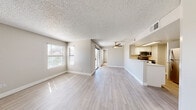 Located at 3800 S Nellis Blvd in Las Vegas, NV, this 2-bedroom, 2-bathroom residence offers a well-organized, single-floor layout designed for comfortable everyday living. The open-concept living and dining area is bright and welcoming, featuring light wood-style flooring, neutral-toned walls, a textured ceiling, and a ceiling fan. Multiple windows invite natural light throughout, while sliding glass doors lead to a private balcony. The kitchen is positioned adjacent to the main living area with a pass-through counter, white cabinetry, light countertops, and a full suite of stainless steel appliances including a refrigerator, range, and microwave. Both bedrooms are carpeted and well-sized, each featuring a closet with sliding doors and windows that bring in natural light. The primary bedroom connects conveniently to its bathroom, which includes a single vanity with a wide mirror and modern light fixtures. A second full bathroom serves the remaining bedroom and guests. A dedicated laundry area houses a full-size washer and dryer with overhead shelving for added storage. The overall aesthetic is clean and neutral, providing a functional and move-in-ready living environment in the heart of Las Vegas.