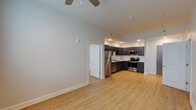 Located in New Orleans, LA 70112, this 2-bedroom, 1-bathroom residence offers a thoughtfully designed single-floor layout that balances comfort and modern functionality. Light-toned hardwood-style flooring runs throughout the entire unit, creating a cohesive and clean aesthetic from room to room.

The open-concept living and kitchen area serves as the heart of the home. The kitchen is equipped with a full suite of stainless steel appliances — including a refrigerator, electric range, built-in microwave, and dishwasher — complemented by rich, dark-stained cabinetry, white countertops, a subway tile backsplash, and a double-basin sink. Recessed lighting illuminates the space effectively.

The living area flows naturally from the kitchen and is fitted with a ceiling fan, while large windows invite an abundance of natural light. Both bedrooms are generously sized, each featuring ceiling fans, wide windows with blinds offering outdoor views, and a calm, neutral color palette that lends itself to versatile use.

The bathroom is clean and functional, featuring a full tub-shower combination, a vanity with dark cabinetry and white countertop, a large mirror, and consistent hardwood-style flooring. The overall ambiance of this unit is modern, bright, and move-in ready, making it a practical and comfortable home in the heart of New Orleans.