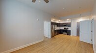 Located in New Orleans, LA 70112, this 2-bedroom, 1-bathroom residence offers a thoughtfully designed single-floor layout that balances comfort and modern functionality. Light-toned hardwood-style flooring runs throughout the entire unit, creating a cohesive and clean aesthetic from room to room.

The open-concept living and kitchen area serves as the heart of the home. The kitchen is equipped with a full suite of stainless steel appliances — including a refrigerator, electric range, built-in microwave, and dishwasher — complemented by rich, dark-stained cabinetry, white countertops, a subway tile backsplash, and a double-basin sink. Recessed lighting illuminates the space effectively.

The living area flows naturally from the kitchen and is fitted with a ceiling fan, while large windows invite an abundance of natural light. Both bedrooms are generously sized, each featuring ceiling fans, wide windows with blinds offering outdoor views, and a calm, neutral color palette that lends itself to versatile use.

The bathroom is clean and functional, featuring a full tub-shower combination, a vanity with dark cabinetry and white countertop, a large mirror, and consistent hardwood-style flooring. The overall ambiance of this unit is modern, bright, and move-in ready, making it a practical and comfortable home in the heart of New Orleans.