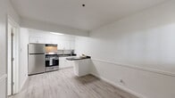 This 330 square foot apartment in Oklahoma City offers a compact yet functional living space. The single-floor layout comprises one bedroom, one bathroom, a kitchen, a living room, and a closet. The primary bedroom, measuring 110 square feet, provides a cozy retreat.

Throughout the apartment, light-colored wood-look flooring creates a sense of continuity and enhances the perception of space. The walls are painted in a neutral white, contributing to a bright and airy atmosphere. Windows with horizontal blinds allow for natural light and privacy control.

The bathroom features a clean, modern design with white tiled walls, a striped shower curtain, and a vanity with a dark countertop. The kitchen boasts white cabinetry, stainless steel appliances, and dark countertops, offering a contemporary look and essential cooking amenities.

Climate control is provided by a wall-mounted air conditioning unit, ensuring comfort year-round. The apartment's efficient design maximizes the use of limited space, making it an ideal option for singles or couples seeking a low-maintenance urban dwelling in Oklahoma City.