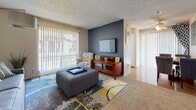 Located in Northglenn, Colorado, this single-floor 1-bedroom, 1-bathroom unit offers a well-organized layout designed for comfortable everyday living. The living room serves as the heart of the home, featuring plush carpeting, a textured ceiling, and large sliding glass doors that invite natural light and provide outdoor views. A bold accent wall adds a modern touch, complemented by ample space for seating and entertainment. Adjacent to the living area, the kitchen is equipped with white cabinetry, a coil-burner electric range, a full-size refrigerator, and a ventilation hood overhead. The flooring transitions to hardwood-style in this area, adding warmth and easy maintenance. A dedicated dining area connects the kitchen to the rest of the unit. The bedroom is a restful retreat, featuring carpeted flooring, a window with blinds and curtain panels for light control, and sufficient space for a full furniture arrangement including a bed, dresser, and accent chair. The full bathroom features tile flooring, a shower-tub combination, and a vanity with countertop space. Throughout the unit, a neutral color palette and textured ceilings create a consistent and understated aesthetic well-suited for both relaxing and everyday functionality.