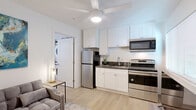 Located at 6343 Rosemead Boulevard in San Gabriel, CA, this efficiently designed one-bedroom, one-bathroom unit makes smart use of its compact footprint across a single floor. Light wood-style flooring runs throughout, creating a cohesive and bright aesthetic in every room.

The open-plan living, dining, and kitchen area serves as the heart of the unit. The kitchen is well-appointed with stainless steel appliances — including a full-size refrigerator, electric range, and over-the-range microwave — paired with white shaker-style cabinetry, dark countertops, and a single-basin sink. A ceiling fan overhead keeps the space comfortable, while a window allows natural light to fill the room. The living area accommodates a seating arrangement and provides direct access to the front entry door.

The bedroom is a calm, well-proportioned retreat, featuring its own ceiling fan, a window for natural light, and two closets for storage. A stacked washer and dryer unit is conveniently tucked behind a curtained nook accessible from this area.

The bathroom is clean and functional, outfitted with a white vanity featuring dark countertops, a tub-shower combo with a patterned curtain, and wood-style flooring consistent with the rest of the unit. A hallway connects the key areas of the home, contributing to an efficient and logical layout throughout.