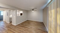 Located at 2723 S Topeka in Wichita, Kansas, this efficient one-bedroom, one-bathroom unit offers a practical and comfortable layout across a single floor. The living area makes a strong first impression with warm wood-look vinyl plank flooring, neutral gray walls, and a ceiling fan that keeps the space bright and airy. A pass-through window connects the living room to the kitchen, featuring white cabinetry and dark appliances, adding an open, communicative feel between the two areas. The bedroom is a comfortable, well-proportioned retreat finished with plush neutral carpet underfoot and equipped with a ceiling fan and light fixture. A generous double-door closet provides ample storage, while a window fitted with horizontal blinds allows for natural light and privacy control. The hallway connects the living spaces seamlessly to the full bathroom, which features a clean, white tub-and-shower combination with a built-in recessed shelf, chrome fixtures, and neutral toned walls. Throughout the unit, consistent neutral tones, clean white trim, and textured ceilings contribute to a cohesive, move-in-ready aesthetic. This unit is a well-designed space that maximizes functionality within a compact, single-story footprint.
