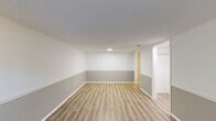 Located at 6 Lamplight Ct in London, Ohio, this single-floor, one-bedroom, one-bathroom home offers a practical and efficiently laid-out living space. The floor plan includes a living room, bedroom, kitchen, bathroom, hallway, and closet — providing all the essential areas for comfortable daily living.

The living room features light-toned luxury vinyl plank flooring and a distinctive two-tone wall treatment, with a crisp white upper half and a cool gray lower panel divided by white chair rail molding. A front-facing window allows natural light to brighten the space, complementing the textured ceiling and clean white trim throughout.

The kitchen is efficiently arranged with white cabinetry, dark countertops, a stainless steel sink, and under-cabinet lighting, offering functional prep and storage space. The layout connects smoothly to the rest of the home via a central hallway.

The bedroom is carpeted for comfort and includes a ceiling fan with light fixture, a window for natural light and ventilation, and access to a dedicated closet. The bathroom is finished in an all-white palette, featuring a tub/shower combination, a toilet, and a vanity with a dark countertop and pendant lighting — consistent with the clean, neutral aesthetic carried throughout the home.