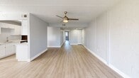 Located at 7231 Maida Ln in Fort Myers, FL, this single-floor 2-bedroom, 2-bathroom unit offers a clean, modern aesthetic throughout. Light wood-style flooring runs seamlessly across all living areas, complementing the crisp white walls and bright, airy atmosphere. The open living room is anchored by a stylish ceiling fan and features a sliding glass door that frames serene waterfront and palm tree views, flooding the space with natural light. The kitchen is well-appointed with white shaker cabinetry, light countertops, a subway tile backsplash, stainless steel appliances including a refrigerator and dishwasher, and a double-basin sink with a brushed gold faucet. A pendant light and natural light from multiple windows enhance the kitchen's inviting feel. The spacious primary bedroom offers generous proportions, ceiling fan, and dedicated closet space. The second bedroom is equally comfortable, with its own closet. Both bathrooms are finished in a clean, neutral palette, featuring white tile, modern vanities with light countertops, and a tub/shower combination. The unit also includes two closets for additional storage. With waterfront scenery and updated finishes throughout, this residence offers a comfortable Florida lifestyle.