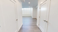 Located at 2665 Geneva Ave in Daly City, CA, this two-story, 2-bedroom, 3-bathroom home offers a thoughtfully designed layout spread across two well-proportioned floors. The main level features an open-concept living and kitchen area with light hardwood-style flooring, recessed lighting, and tall ceilings that create an airy, expansive feel. The kitchen is a standout, showcasing grey shaker cabinetry, quartz countertops, stainless steel appliances, a central island with a sleek overhead range hood, and ample storage throughout. Large windows flood the space with natural light. The upper floor hosts the bedrooms, including a generously sized primary bedroom with plush carpeting, exposed piping details that lend an industrial character, and windows offering outdoor views. The second bedroom mirrors this aesthetic with the same carpet and bright, clean walls. Three well-appointed bathrooms feature marble-look tile, soaking tub-shower combos, and brushed gold fixtures, adding a refined touch. A dedicated in-unit laundry room with a full-size washer and dryer adds everyday convenience. Two staircases connect the floors, enhancing the home's functional flow. The overall ambiance is clean, modern, and move-in ready.