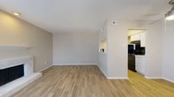 Located at 803 Cottoncreek Cir in Arlington, TX, this one-bedroom, one-bathroom two-story home offers a practical and well-organized layout spread across two floors. The main level features an open living room with warm wood-look flooring, neutral-toned walls, a textured ceiling, and a ceiling fan near the entryway. A large front window allows generous natural light to fill the space. A half-wall pass-through connects the living area to the galley-style kitchen, which is outfitted with white cabinetry, light stone countertops, and black appliances including a range and refrigerator, all set over matching wood-look flooring. The upper level hosts the generously sized bedroom, carpeted for comfort, with a large window that offers outdoor views and direct access to a spacious walk-in closet featuring built-in shelving. The full bathroom is finished with wood-look tile flooring, a white vanity with stone-topped counters, a large mirror, and a shower/tub combination. A hallway connects the upper-level spaces efficiently. Throughout the home, a consistent neutral color palette and clean finishes create a calm, move-in-ready atmosphere suited for comfortable everyday living.