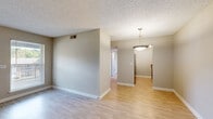 Located at 530 Harding Pl in Nashville, TN, this single-floor, 2-bedroom, 2-bathroom home offers a functional and comfortable layout with clean, neutral finishes throughout. The living area welcomes you with light wood-style laminate flooring, warm beige walls, and a textured ceiling, with a front entry door and window that invite natural light into the space. The kitchen features granite-style countertops paired with dark cabinetry, offering ample storage and workspace. The living and dining areas continue the light flooring for a cohesive, open feel. Both bedrooms are carpeted for warmth and comfort, each equipped with a ceiling fan and light fixture, and windows that bring in natural light with views of surrounding greenery. The primary bedroom is a well-sized retreat with easy access to closet space. The two bathrooms are finished consistently, featuring dark cabinetry with granite-style countertops, a single vanity sink, light wood-style tile flooring, and a tub-shower combination. A hallway and dedicated closet complete the thoughtfully organized layout. The home's neutral color palette and consistent finishes create a calm, move-in-ready ambiance throughout.