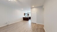 Located at 600 E Marble St in Wylie, TX, this single-story, 2-bedroom, 1-bathroom home offers a thoughtfully designed layout with consistent modern finishes throughout. Light-toned luxury vinyl plank flooring flows seamlessly across every room, creating a cohesive and easy-to-maintain aesthetic.

The open kitchen and living area serves as the heart of the home. The kitchen is outfitted with rich dark-espresso cabinetry, granite-look countertops, a central island, and a full suite of stainless steel appliances including a refrigerator with ice maker, electric range, built-in microwave, and dishwasher. A large window over the sink brings in natural light, brightening the space.

The living room is generously sized with a ceiling fan, a front-facing window, and a sliding glass door offering access to the outdoors. Both bedrooms are well-proportioned and bright, each featuring ceiling fans and windows with blinds. The spacious primary bedroom includes a walk-in closet for ample storage. The bedroom hallway provides convenient access to the dedicated laundry room, which accommodates a full-size washer and dryer.

The bathroom features a clean, all-white tub-shower combo, wood-toned cabinetry, granite countertops, and matching vinyl flooring. The overall design is clean, neutral, and move-in ready.