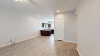 Located at 600 E Marble St in Wylie, TX, this single-story, 2-bedroom, 1-bathroom home offers a thoughtfully designed layout with consistent modern finishes throughout. Light-toned luxury vinyl plank flooring flows seamlessly across every room, creating a cohesive and easy-to-maintain aesthetic.

The open kitchen and living area serves as the heart of the home. The kitchen is outfitted with rich dark-espresso cabinetry, granite-look countertops, a central island, and a full suite of stainless steel appliances including a refrigerator with ice maker, electric range, built-in microwave, and dishwasher. A large window over the sink brings in natural light, brightening the space.

The living room is generously sized with a ceiling fan, a front-facing window, and a sliding glass door offering access to the outdoors. Both bedrooms are well-proportioned and bright, each featuring ceiling fans and windows with blinds. The spacious primary bedroom includes a walk-in closet for ample storage. The bedroom hallway provides convenient access to the dedicated laundry room, which accommodates a full-size washer and dryer.

The bathroom features a clean, all-white tub-shower combo, wood-toned cabinetry, granite countertops, and matching vinyl flooring. The overall design is clean, neutral, and move-in ready.
