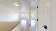 Located at 14339 Whittier Blvd in Whittier, CA, this well-appointed one-bedroom, one-bathroom unit offers a thoughtfully designed open-concept layout. Wood-look luxury vinyl plank flooring flows seamlessly throughout the entire space, lending a clean and cohesive aesthetic.

The living room is generously proportioned, bathed in natural light from a large multi-pane window and offering direct access to a private balcony through a glass-panel door — perfect for enjoying outdoor views. Recessed lighting enhances the bright, airy atmosphere.

The kitchen is a standout feature, boasting white shaker cabinetry, gray quartz countertops, and a central island ideal for meal prep or casual dining. A full suite of stainless steel appliances — including a refrigerator, gas range, built-in microwave, and dishwasher — completes this functional and stylish culinary space.

The bedroom is a calm, well-sized retreat with crisp white walls, a ceiling vent for climate control, and a full-width sliding closet offering ample storage.

The bathroom is clean and modern, featuring white panel walls, a full soaking tub with shower, and warm wood-look flooring that ties the space together. The overall design is minimal, fresh, and move-in ready.
