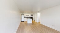 Located in Melbourne, FL, this efficiently designed one-bedroom, one-bathroom unit offers a clean, modern aesthetic across a single floor. Light hardwood-style flooring runs throughout the space, creating a cohesive and airy feel. The open-concept living, dining, and kitchen area serves as the heart of the unit, maximizing functionality. The kitchen is well-appointed with white shaker-style cabinetry, dark granite countertops, a tile backsplash, stainless steel appliances including a refrigerator, range, and microwave, and a central island that provides additional prep and storage space. A deep utility sink with a modern faucet adds a practical touch. The living area receives natural light through a large window overlooking the landscaped grounds. The bedroom is a comfortable, well-proportioned room with a ceiling fan, a natural light-filled window, and a dedicated closet with built-in shelving. The bathroom features marble-style tile flooring, white shaker vanity with granite countertop, and a fully tiled tub-shower combination with clean white subway tiles and matte black fixtures. Three closets offer ample storage throughout the unit. Outside, the property is surrounded by lush green lawns and mature palm and shade trees.