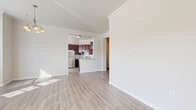 Located at 825 Beverley Dr in Charlottesville, Virginia, this well-appointed single-floor home offers three bedrooms, two bathrooms, and a thoughtfully designed layout across a comfortable and functional floor plan. The bright living room serves as the heart of the home, featuring light wood-tone flooring, crown molding, a ceiling fan, a tiled fireplace, and windows that invite natural light throughout the space. The kitchen is open and efficient, outfitted with rich dark wood cabinetry, granite countertops, and a full suite of stainless steel appliances including a refrigerator, electric range, and dishwasher. The primary bedroom is generously sized, with plush carpeting and ample natural light. It connects to a well-finished bathroom showcasing a granite-topped double vanity with dark wood cabinetry and dual mirrors. The additional bedrooms also feature carpet flooring and ceiling fans, providing comfortable, flexible living spaces. Three closets, including a spacious walk-in with wire shelving, offer substantial storage throughout the home. A dedicated laundry room with a full-size washer and additional shelving adds everyday convenience. The layout is connected by hallways that create a smooth and logical flow between all areas of the home.