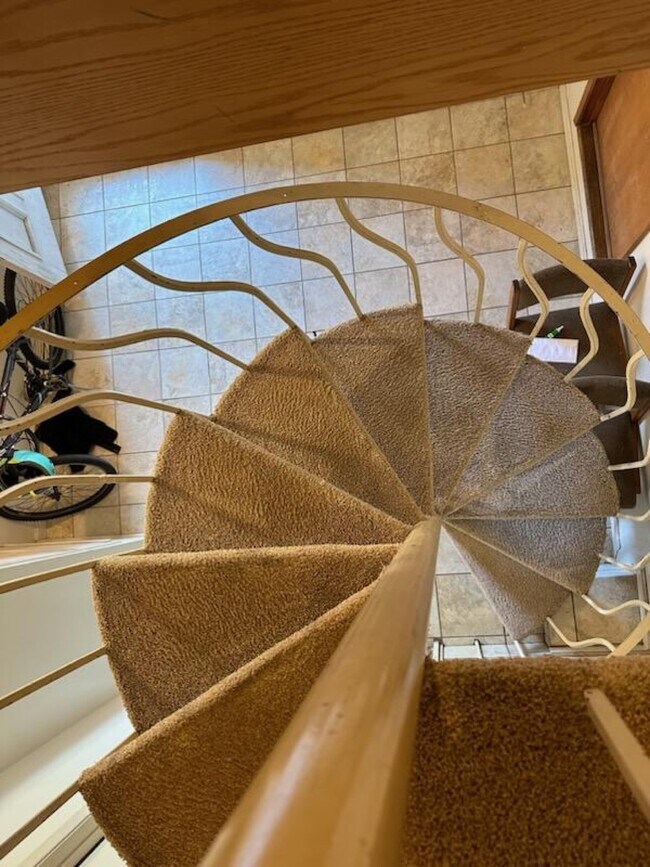 Spiral staircase to accessory apartment - 570 E Claremont St