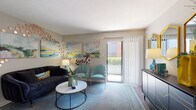 This single-floor residence showcases a thoughtfully designed layout that balances comfort and contemporary style throughout. The living area serves as the centerpiece of the home, featuring a plush navy sofa, teal accent chairs, and a marble-top coffee table set atop a blue area rug. Colorful abstract artwork and decorative copper disc wall arrangements add artistic character to the neutral-toned walls, while a sliding glass door fills the room with natural light and provides direct access to an outdoor patio. The galley-style kitchen is efficiently organized with rich dark wood cabinetry, granite countertops, and black stainless appliances including a refrigerator, electric range, microwave, and dishwasher, all set above durable hardwood-style flooring. The primary bedroom is a serene retreat, highlighted by a tall upholstered headboard, a ceiling fan, and a walk-in closet, complemented by warm accent lighting and decorative wall art. A secondary bedroom offers ample natural light through large windows with blinds, a ceiling fan, and hardwood-style flooring. The bathroom features a full-size soaking tub and shower combination with clean white surrounds and stylish geometric-patterned curtain accents. Throughout the residence, a cohesive teal and neutral color palette creates a warm, inviting ambiance.