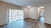 This contemporary apartment offers 1040 square feet of thoughtfully designed living space. The open-concept layout features a modern kitchen with dark wood cabinetry, granite countertops, and stainless steel appliances. The living area boasts wood-look flooring and large windows, allowing natural light to flood the space. Two bedrooms, each with plush carpeting and ceiling fans, provide comfortable retreats. The bathrooms showcase neutral tiled floors and tub/shower combinations. Ample closet space and a dedicated laundry area add convenience. The overall design emphasizes clean lines and a neutral color palette, creating a versatile and inviting home environment.