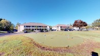 Located at 7150 Bent Tree Boulevard in Columbus, Ohio, this property is a multi-building complex set against a backdrop of mature trees and open green space. The exterior showcases a classic architectural style with low-pitched hip roofs, covered balconies or walkways along the building facades, and neutral-toned siding that gives the complex a cohesive, professional appearance. The buildings are arranged to frame a generous shared outdoor area, creating a sense of openness and community.

A notable highlight of the outdoor grounds is a dedicated putting green, complete with multiple flags and a well-maintained synthetic turf surface. This amenity adds a recreational dimension to the property and speaks to the thoughtful attention given to outdoor living spaces. The surrounding landscape features neatly kept grass areas and established trees that provide seasonal color and natural shade.

Ample surface parking is available on-site, with clearly delineated spaces accessible from the main drive. The property's single-floor layout across its buildings promotes ease of access throughout the complex. The combination of practical amenities, well-groomed outdoor spaces, and the classic Midwest architectural character makes this Columbus property a functional and inviting destination. Its location along Bent Tree Boulevard places it within a well-established Columbus corridor.