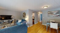 Located at 38 1/2 Wolden Rd in Ossining, NY, this single-floor residence offers a well-organized and cohesive layout designed for comfortable everyday living. Warm-toned hardwood floors extend throughout the main areas, contributing to a bright and inviting atmosphere.

The open living and dining area serves as the heart of the home, providing generous space for both relaxing and entertaining. Natural light filters in through windows overlooking the outdoors, enhancing the airy feel of the room. The living area connects seamlessly to a dedicated dining space, creating a natural flow throughout.

The galley-style kitchen is efficiently designed and well-appointed, featuring stainless steel appliances including a refrigerator, electric range, microwave, and dishwasher. White cabinetry, dark countertops, and a classic subway tile backsplash give the kitchen a clean, modern aesthetic, while wood-look flooring grounds the space.

The bedroom is comfortably sized, offering natural light through double windows and includes a closet with hanging storage. Its soft gray walls and hardwood flooring maintain the consistent, neutral palette found throughout the home.

The bathroom is finished with large-format neutral tiles, a soaking tub with tiled surround, and dark wood vanity cabinetry, creating a clean and relaxing space. Overall, this residence presents a cohesive, move-in-ready interior in a convenient Ossining location.