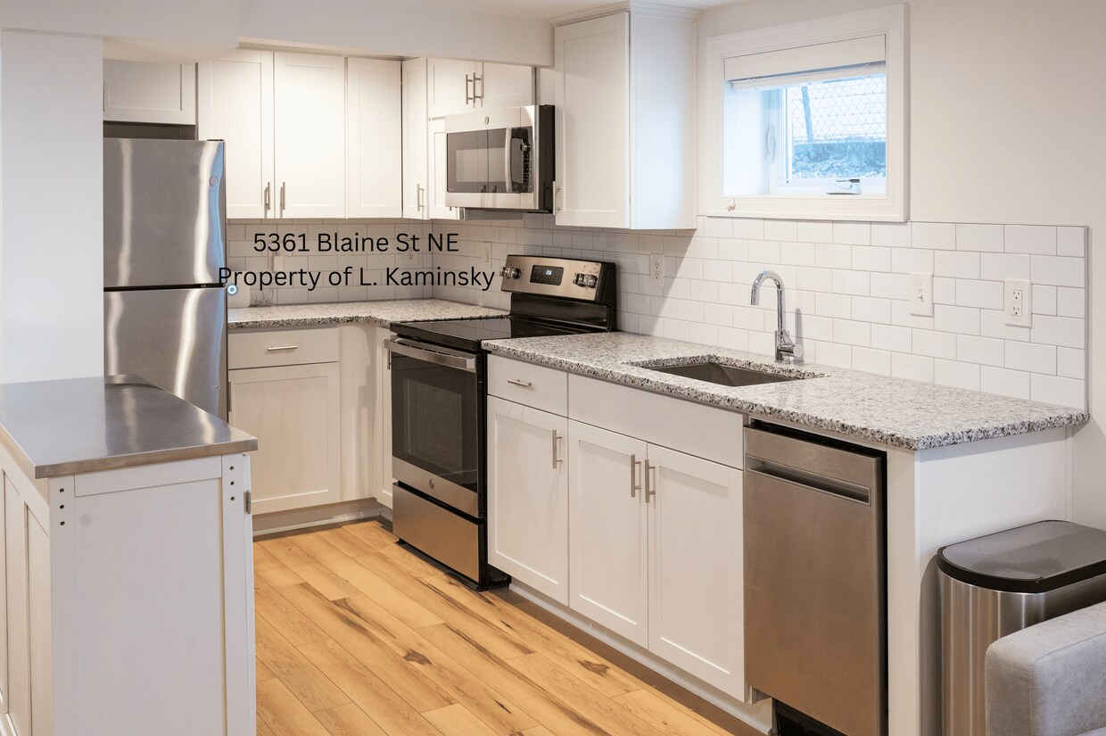 Full kitchen with granite countertops, stainless steeel appliances, and dishwasher - 5361 Blaine St NE