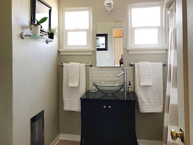 Sunny, spacious bathroom blending modern and retro. Bathroom is between the two bedrooms. - 3416 Mackland Ave NE