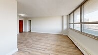This 63 square meter apartment, located at 10-50 Carabob Crt in Toronto, offers a well-designed living space on a single floor. The layout comprises one bedroom, one bathroom, a combined kitchen and living room, and a hallway, creating a functional and compact urban dwelling.

The primary bedroom, measuring 16 square meters, provides a spacious retreat with large windows allowing natural light to flood the room. The living area features an open-concept design, seamlessly connecting the kitchen and living spaces. Light-toned wood-look flooring throughout adds warmth and continuity to the space.

The kitchen boasts modern white cabinetry, stainless steel appliances, and a practical layout with ample counter space. A window in the kitchen area offers views and natural light, enhancing the cooking experience.

The bathroom is equipped with a full-sized bathtub and shower combination, surrounded by pristine white tiling for a clean, contemporary look. Modern fixtures and a minimalist design create a functional and aesthetically pleasing space.

Large windows in the living area and bedroom not only provide abundant natural light but also offer views of the surrounding urban landscape. The apartment's neutral color palette, dominated by whites and light tones, creates a bright and airy atmosphere throughout.

Built-in storage solutions, including closets with sliding doors, maximize the use of space in this compact yet efficiently designed apartment. Ceiling-mounted light fixtures provide even illumination throughout the living spaces.

This apartment combines modern amenities with a practical layout, making it an ideal choice for those seeking a contemporary urban living experience in Toronto.