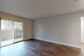 Located at 1281 Brockett Rd in Clarkston, GA, this single-floor, 1-bedroom, 2-bathroom residence offers a thoughtfully organized layout that maximizes every square foot. Dark hardwood-style flooring flows throughout the main living areas, creating a warm and cohesive aesthetic. The open-concept living and dining area is bright and welcoming, highlighted by a sliding glass door that opens to a private patio, inviting natural light and outdoor views into the space.

The kitchen is efficiently designed with crisp white shaker-style cabinetry, granite countertops, a stainless steel sink, and black appliances including a range and refrigerator. A pantry and utility room add practical storage and functionality. The bedroom is a comfortable retreat featuring plush carpeting, two large windows that fill the room with natural light, and access to multiple closets for ample storage.

Both bathrooms are clean and well-maintained. One features a wide granite-topped vanity with white cabinetry and modern fixtures, complemented by hardwood-style flooring. The second bathroom includes a full tub-shower combination. Neutral gray walls throughout the residence provide a versatile, move-in-ready backdrop. With three closets total, a pantry, and a utility room, this home delivers practical storage solutions alongside its inviting design.