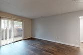 Located at 1281 Brockett Rd in Clarkston, GA, this single-floor, 1-bedroom, 2-bathroom residence offers a thoughtfully organized layout that maximizes every square foot. Dark hardwood-style flooring flows throughout the main living areas, creating a warm and cohesive aesthetic. The open-concept living and dining area is bright and welcoming, highlighted by a sliding glass door that opens to a private patio, inviting natural light and outdoor views into the space.

The kitchen is efficiently designed with crisp white shaker-style cabinetry, granite countertops, a stainless steel sink, and black appliances including a range and refrigerator. A pantry and utility room add practical storage and functionality. The bedroom is a comfortable retreat featuring plush carpeting, two large windows that fill the room with natural light, and access to multiple closets for ample storage.

Both bathrooms are clean and well-maintained. One features a wide granite-topped vanity with white cabinetry and modern fixtures, complemented by hardwood-style flooring. The second bathroom includes a full tub-shower combination. Neutral gray walls throughout the residence provide a versatile, move-in-ready backdrop. With three closets total, a pantry, and a utility room, this home delivers practical storage solutions alongside its inviting design.