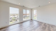 Located at 1101 Lady St in the heart of downtown Columbia, SC, this modern 2-bedroom, 2-bathroom residence offers a clean, contemporary aesthetic throughout its well-appointed single floor. Wood-look plank flooring flows seamlessly across the living spaces, complementing the bright white walls and creating a warm yet modern ambiance.

The galley-style kitchen is thoughtfully designed with white cabinetry, open floating shelves, white quartz countertops, a white subway tile backsplash, and a full suite of stainless steel appliances. A window above the counter allows natural light to pour in while offering views of the surrounding cityscape.

The living area is bathed in natural light through expansive floor-to-ceiling windows that frame sweeping views of the Columbia skyline, providing an airy, open feel. A glazed exterior door leads to an outdoor balcony, further connecting the interior to its urban surroundings.

Both bedrooms feature large windows with city views, wood-look flooring, and ceiling fans. The primary bedroom includes an en-suite bathroom with marble-look tile flooring, a soaking tub with a full-height marble tile surround, white cabinetry with black hardware accents, and access to a dedicated walk-in closet. The second bathroom mirrors this refined aesthetic, maintaining a consistent, polished design throughout the residence.