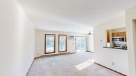 This 760 square foot apartment in Madison, Wisconsin, offers a practical and efficient living space. The single-floor layout comprises three bedrooms, one bathroom, and a combined kitchen and living area. The kitchen is a highlight, featuring modern amenities with wooden cabinetry, granite countertops, and stainless steel appliances. A convenient in-unit laundry area adds to the apartment's functionality.

The bathroom is well-appointed with a bathtub-shower combination, a single vanity with ample storage, and clean, white tiles. The bedrooms, while compact, offer carpeted floors and large windows that allow natural light to flood the spaces. The living area also benefits from carpeting and multiple windows, creating a bright and inviting atmosphere.

Throughout the apartment, neutral tones dominate, with white walls and warm wood accents in the trim and doors. The property features baseboard heating for comfort during Wisconsin winters. Despite its modest size, the apartment's layout efficiently utilizes the available space, making it suitable for small families or individuals seeking a cozy yet functional living environment in a suburban setting.