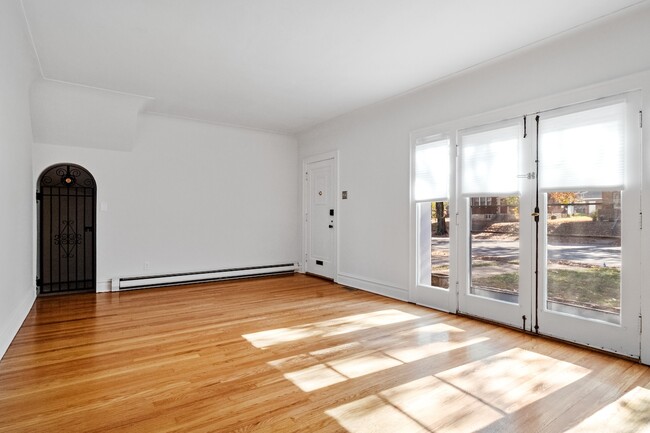 Front door opens to living room from entry foyer, bonus storage space with vintage wrought iron door - 7737 Delmar Blvd