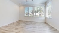 Located at 1930 T St in Sacramento's vibrant Midtown neighborhood, this single-story 2-bedroom, 1-bathroom unit offers a clean, modern aesthetic throughout. The open living area is bright and airy, featuring light wood-style luxury vinyl plank flooring and large windows fitted with blinds that allow generous natural light to fill the space. A ceiling fan adds comfort to the living area, which also enjoys views of the surrounding streetscape.

The kitchen is well-appointed with white shaker-style cabinetry, light quartz countertops, and a full suite of stainless steel appliances including a refrigerator, range, dishwasher, and microwave. Light wood flooring continues seamlessly from the living area into the kitchen, reinforcing the cohesive, contemporary design.

Both bedrooms are carpeted for comfort and feature neutral white walls. The primary bedroom includes a sliding-door closet and a window with natural light, while the second bedroom is equally well-sized with its own window. The full bathroom is outfitted with wood-style flooring, a white vanity, and a tub/shower combination featuring ADA-compliant grab bars for added accessibility. The unit's clean, minimal design and modern finishes make it a functional and comfortable home.