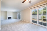 Located at 2520 Ryan Rd in Concord, CA, this single-floor, 2-bedroom, 2-bathroom home offers a well-organized layout across a comfortable footprint. The living area is a standout space, featuring a fireplace, soft carpet flooring, crown molding, and abundant natural light courtesy of sliding glass doors and French doors that open to the outdoors. The kitchen is equipped with granite-style countertops, white cabinetry, a stainless steel sink, and a dishwasher, with a window overlooking the exterior providing additional natural light. The spacious primary bedroom includes dual closets with bifold doors offering generous storage, a ceiling fan, crown molding, and carpet flooring. The second bedroom is similarly appointed with a ceiling fan, carpet, and a window that brings in natural light. The two bathrooms are well-appointed — one features a glass-enclosed walk-in shower with tile surround and a granite-topped vanity, while the other offers a full soaking tub with classic white subway tile. A dedicated laundry room with a full-size washer and dryer and built-in wire shelving adds practical convenience. Crown molding and ceiling fans are consistent throughout, lending a cohesive, polished feel to the entire home.