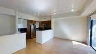 Located at 1801 L St, this modern two-floor space is designed with clean lines and contemporary finishes throughout. The open-concept layout seamlessly connects the kitchen and living area, creating a bright and functional environment. The kitchen is well-appointed with rich dark wood cabinetry, dark stone countertops, stainless steel appliances including a refrigerator and built-in microwave, and a peninsula that provides both additional workspace and a natural division between the kitchen and the living area. Track lighting along the ceiling ensures the kitchen is well-lit and practical. The living area features light hardwood flooring that extends throughout, contributing to a warm and cohesive aesthetic. White walls and a smooth white ceiling amplify the sense of openness, while natural light filters in to enhance the overall ambiance. The two-floor layout offers added versatility and separation of spaces, making this property well-suited for a variety of uses. The combination of modern materials, thoughtful design, and an open floor plan creates an inviting and contemporary atmosphere throughout the space.