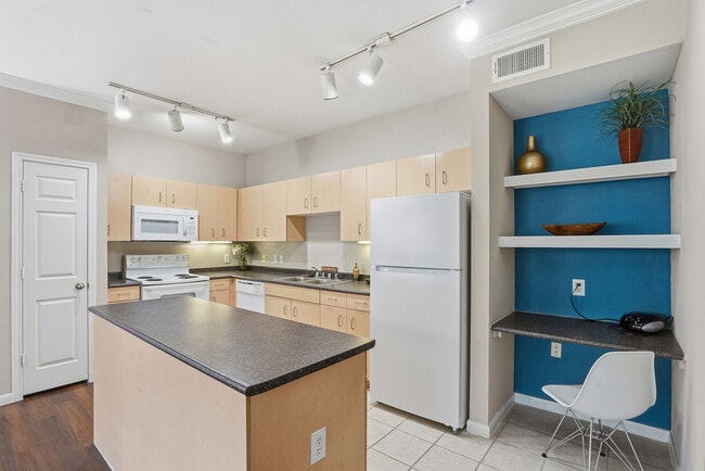 Kitchen equipped with an island, pantry and a built in shelving and computer space - Grand Estates at Kessler Park