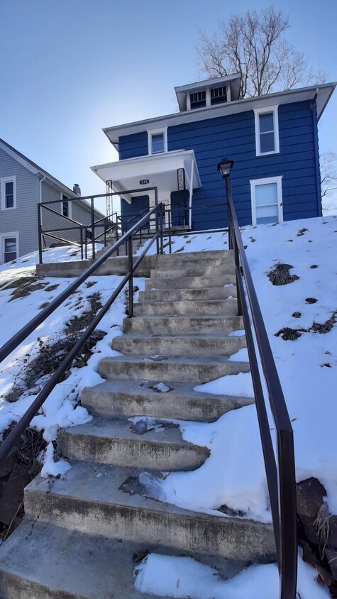 New cement stairway with safe and sturdy metal railing - 715 W 6th St