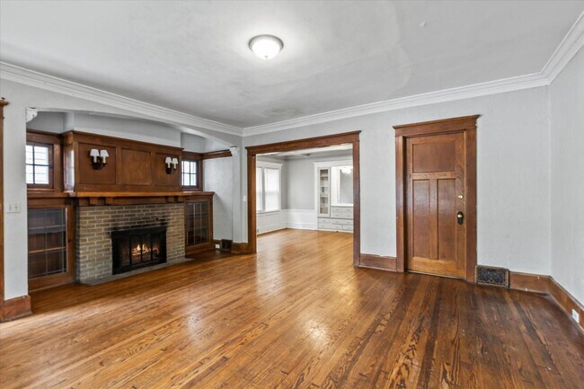 living room with fireplace and built in cabinets - 1806 E Newberry Blvd